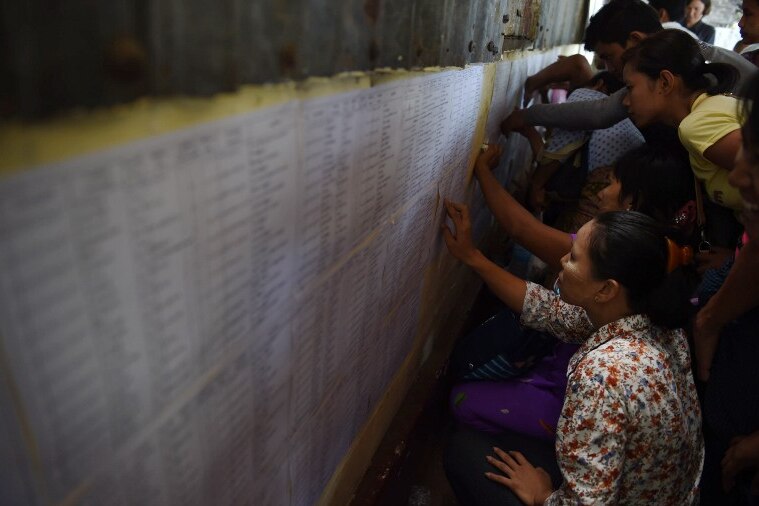Relatives check lists of prisoners due for release at Insein prison in Yangon.