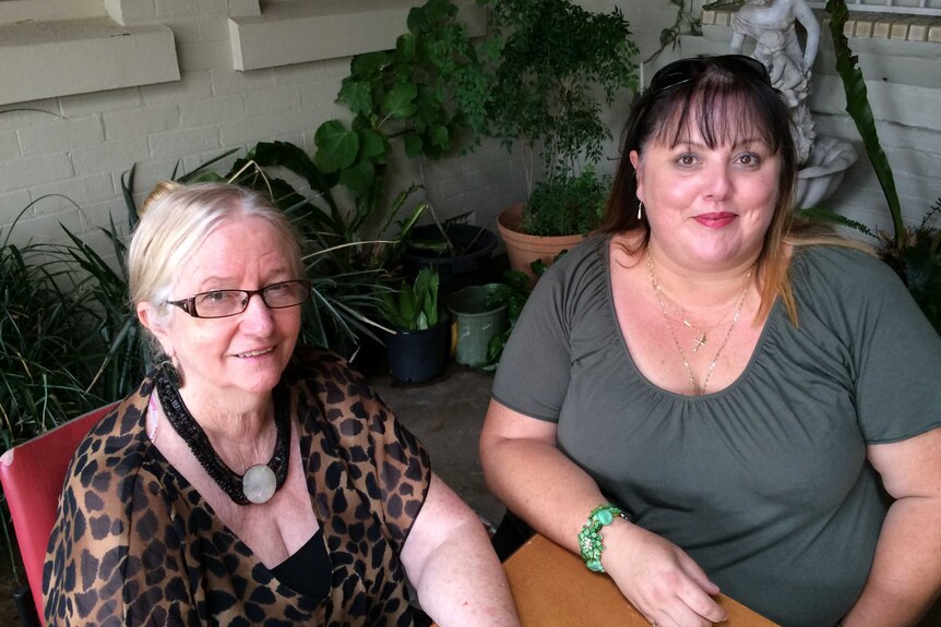 Liz Berger and Maree Holman sit in the pub's back yard.