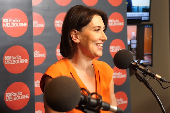 Virginia Trioli smiles while in a radio studio.