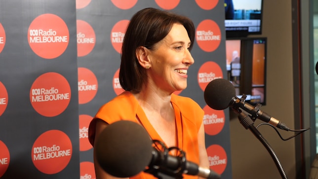 Virginia Trioli smiles while in a radio studio.