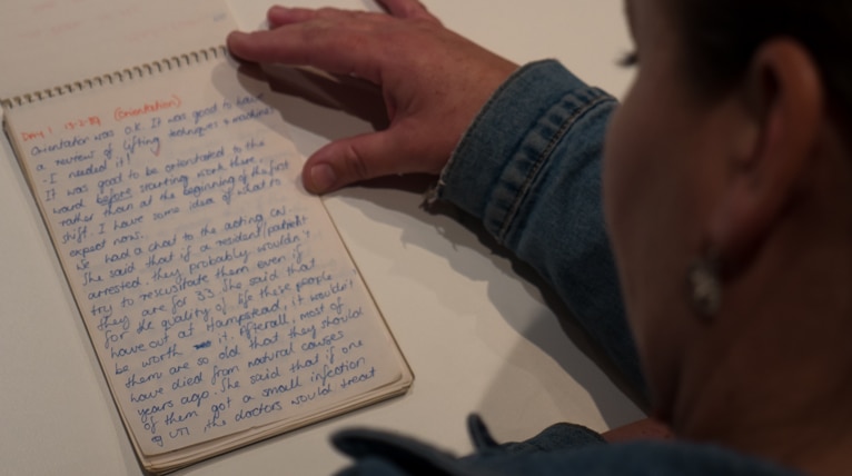 Michelle Judd looks over her notes on her placement at Ward C in 1989.