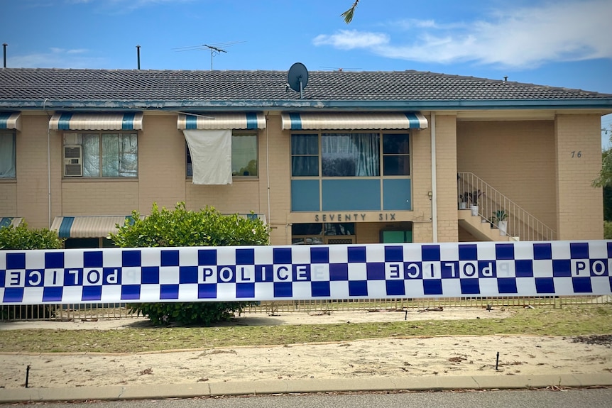  Double-storey unit complex with a fabric sheet covering a window on upper floor 