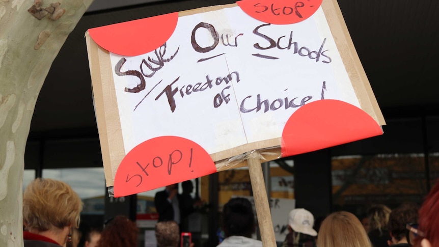 A group of people holding protest signs