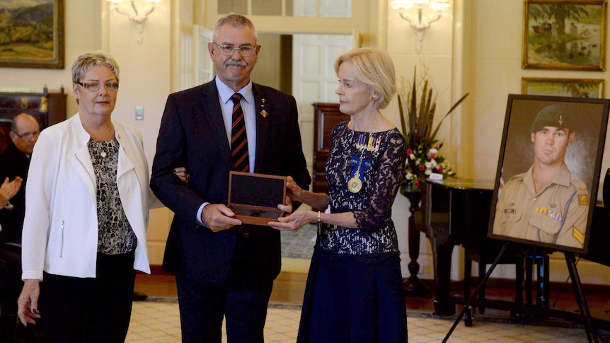 Quentin Bryce presents Cameron Baird's parents with the Victoria Cross.