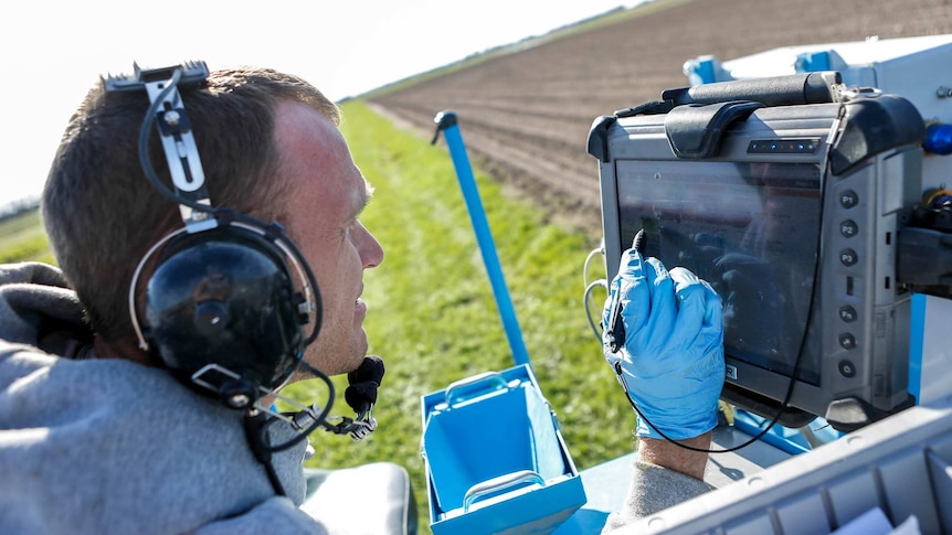GPS mapping systems and computers help plot out a corn field.