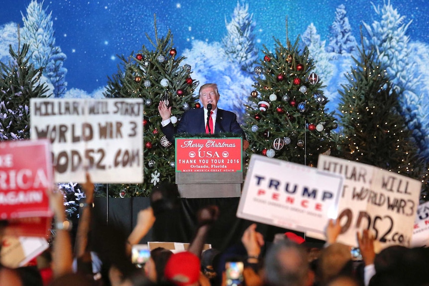 Trump supporters hold up signs at Florida Rally