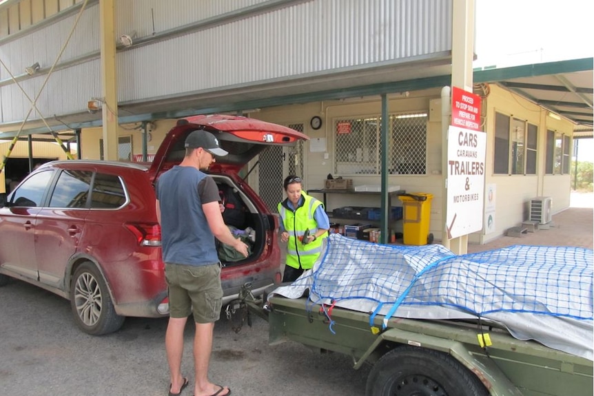 Cars travel through the quarantine checkpoint on the WA-SA border.