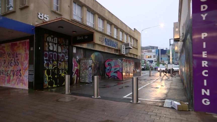 A heavily graffitied laneway.