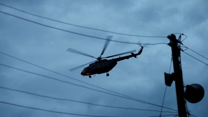 Helicopter flying in a cloudy sky