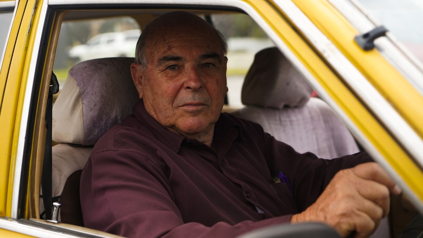 Man in yellow car 