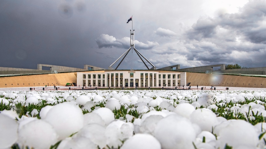 Ground eye view of large hailstones on the lawn in front of Federal Parliament