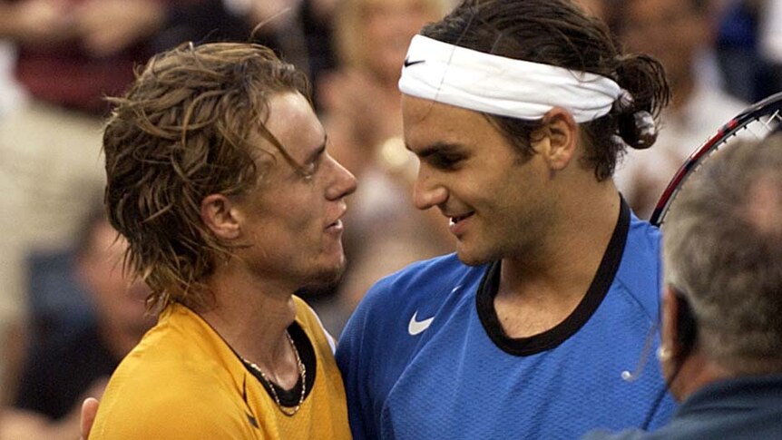 Roger Federer and Lleyton Hewitt talk after Hewitt's loss in the 2004 US Open men's singles final.