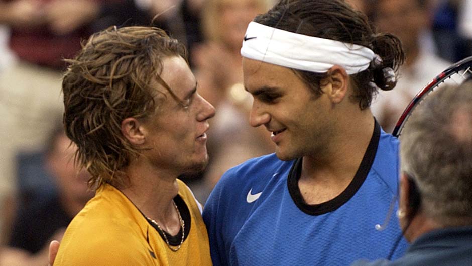 Roger Federer and Lleyton Hewitt talk after Hewitt's loss in the 2004 US Open men's singles final.