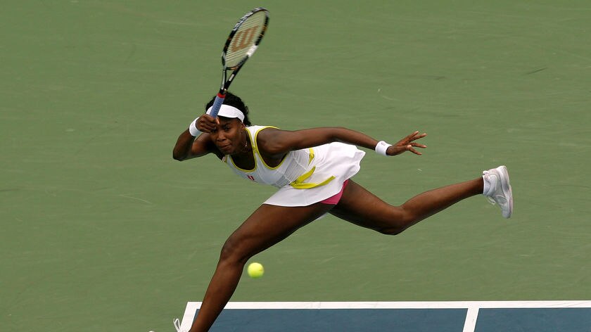 Venus Williams hits a return against Alona Bondarenko