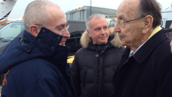 Mikhail Khodorkovsky shakes hands with Hans-Dietrich Genscher upon arrival at Schoenefeld airport in Berlin.