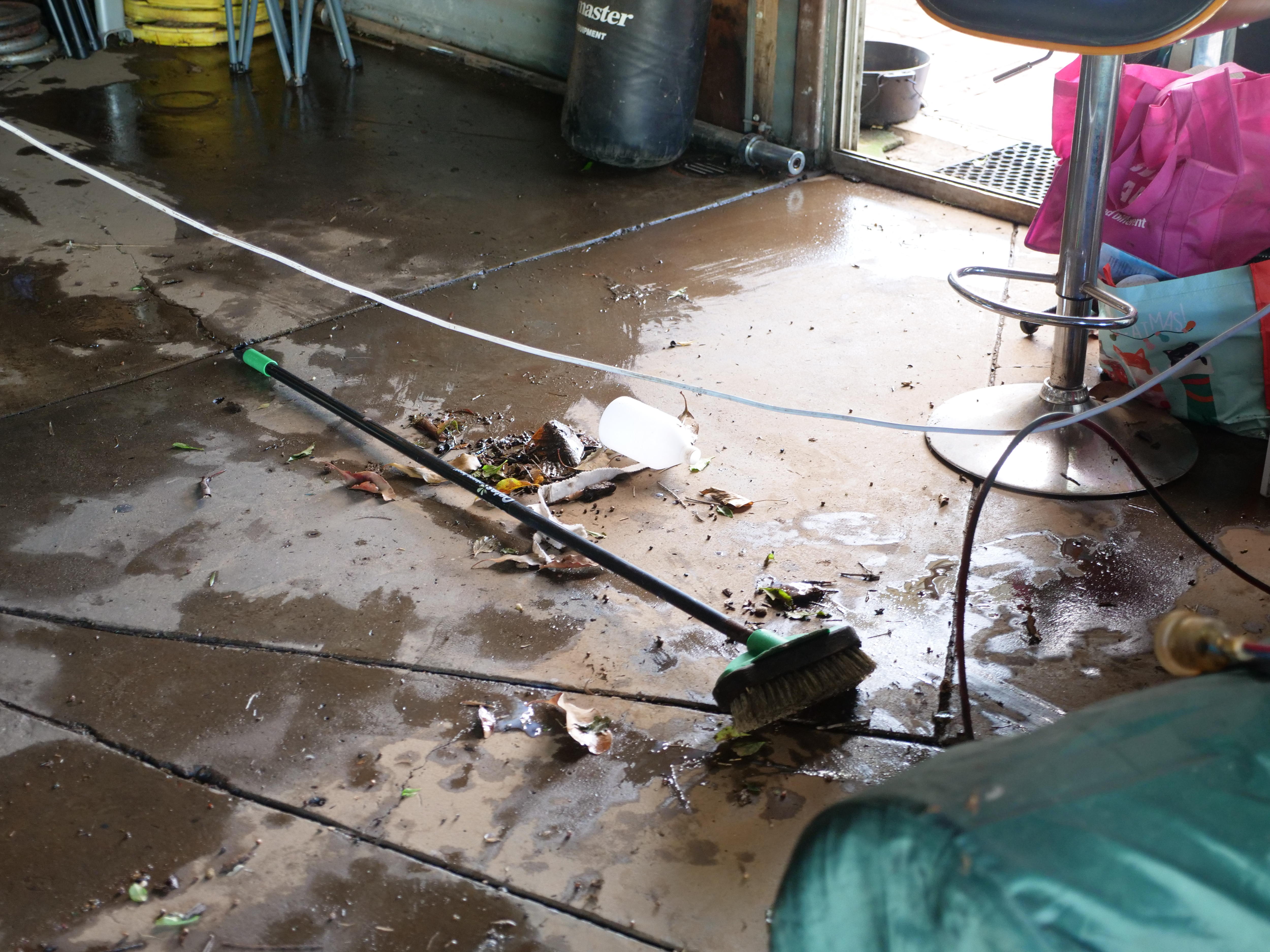 Concrete floor with debring and a broom