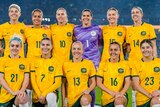 Matildas players pose for a team photo before a game against China.