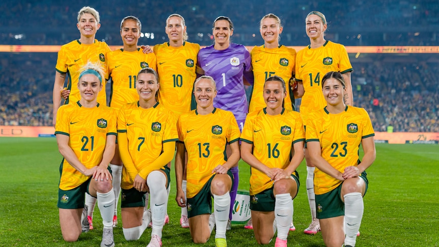 Matildas players pose for a team photo before a game against China.