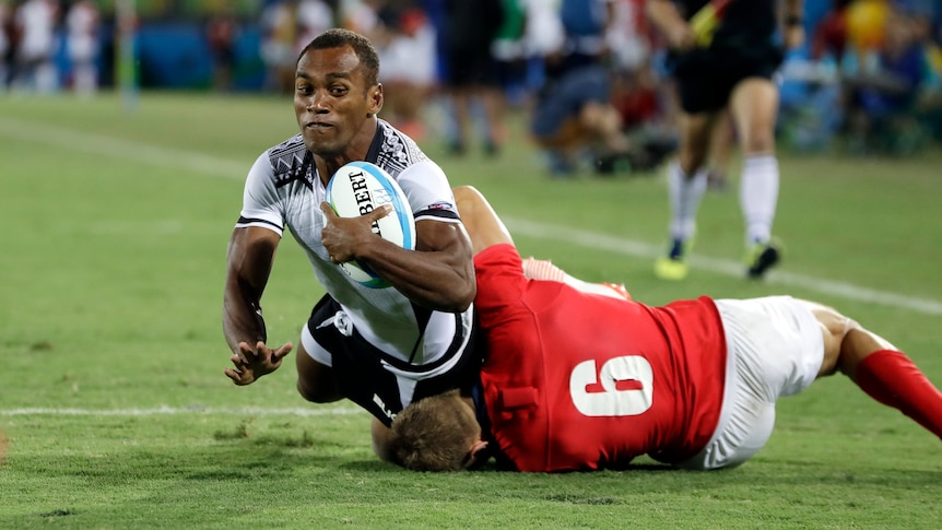 Fiji's Osea Kolinisau scores a try