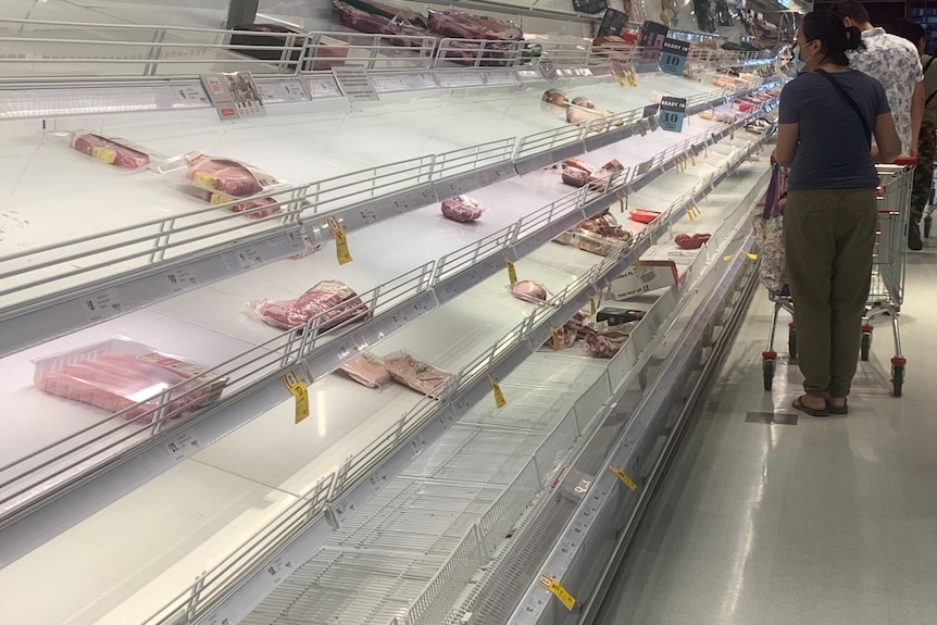 Empty meat shelves in a supermarket.