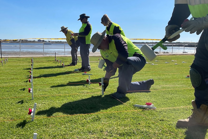 council workers installing remembrance crosses