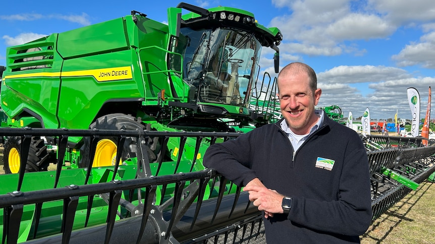 Man standing in front of harvester