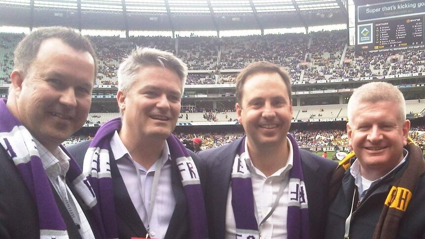 Tasmanian Senator David Bushby, Finance Minister Mathias Cormann and Trade Minister Steve Ciobo at an AFL Grand Final match.