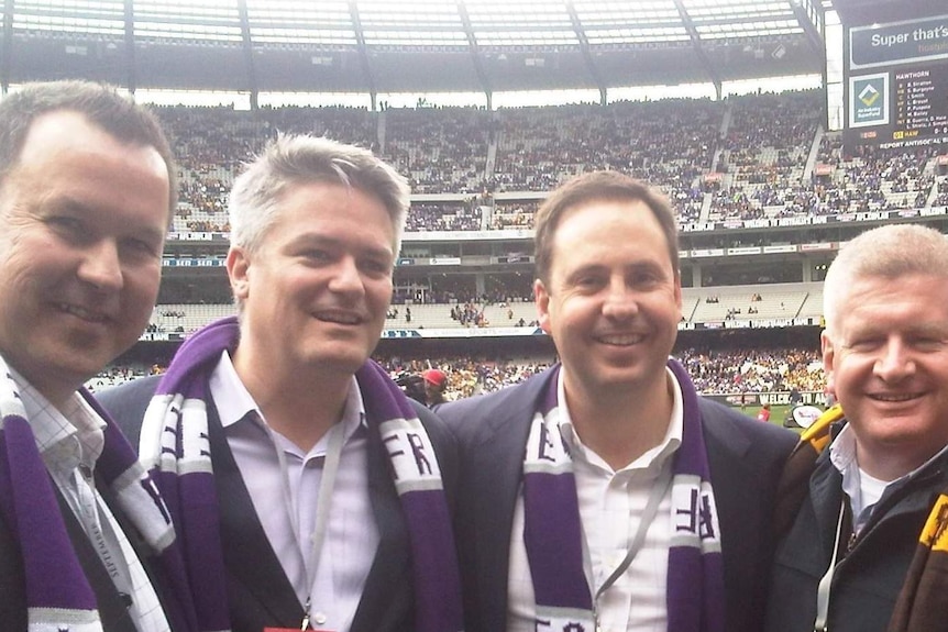 Tasmanian Senator David Bushby, Finance Minister Mathias Cormann and Trade Minister Steve Ciobo at an AFL Grand Final match.