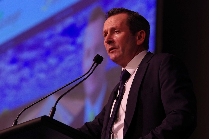 A head and shoulders shot of Mark McGowan speaking at a lectern.