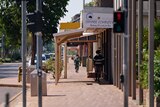 Residents wearing masks walking up the main street during the COVID-19 outbreak lockdown of Katherine.