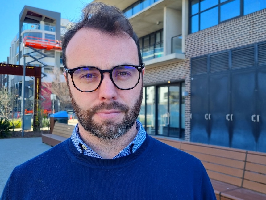 A young man with glasses.