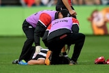Dylan Roberton of the Saints lays on the ground after fainting against Geelong at Kardinia Park.