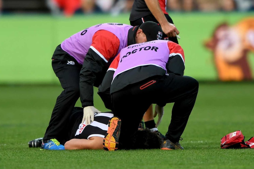 St Kilda's Dylan Roberton lies on the ground after collapsing against Geelong