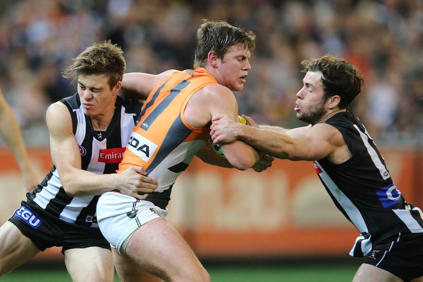 GWS' Taylor Adams gets caught with the ball against Collingwood at the MCG.