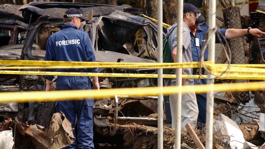 Australian Federal Police forensic experts sift through the rubble in Kuta.