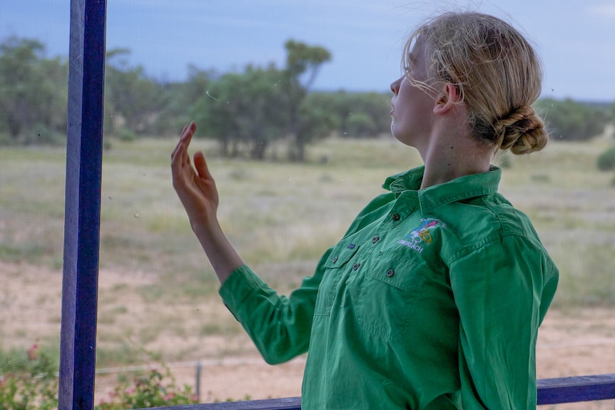 Lucy Faggotter dancing on her verandah, west of Longreach, November 2022.