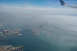 A view of Sydney Harbour and greater Sydney shrouded in smoke.
