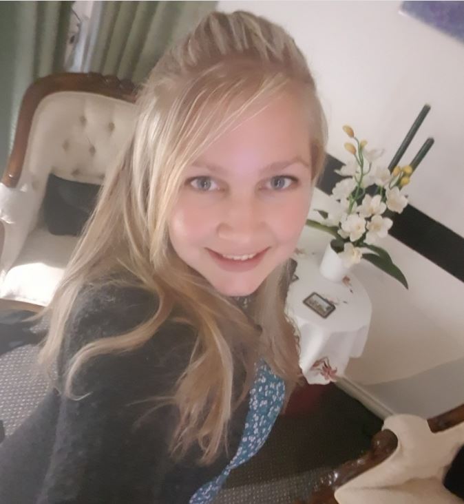 Hannah Fraser pictured with her long blonde hair down in a lounge room