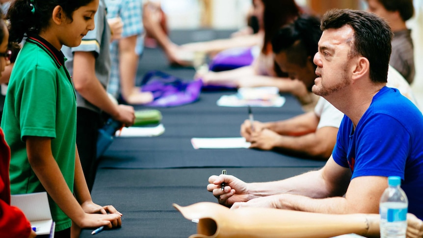 Robert Hoge talks to a young fan at the Brisbane Writers Festival in 2013.