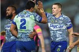 Bulldogs players celebrate a try against Penrith
