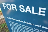 A for sale sign outside a house in Brisbane