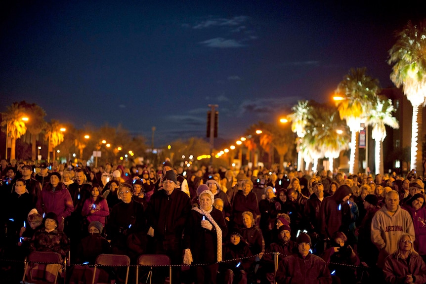 People at a vigil for victims and survivors of the shooting.