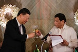 Philippine President Rodrigo Duterte proposes a toast to Chinese President Xi Jinping during a state banquet in Manila.