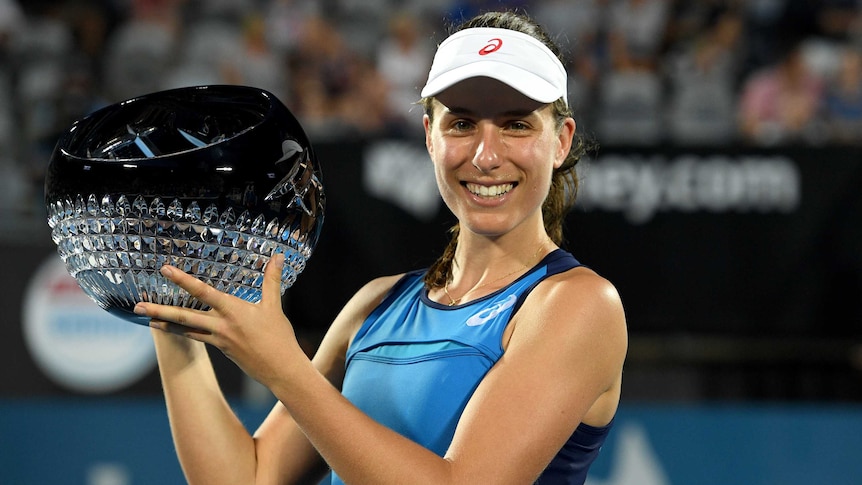 Johanna Konta holds Sydney International trophy after beating Agnieszka Radwanska in final.