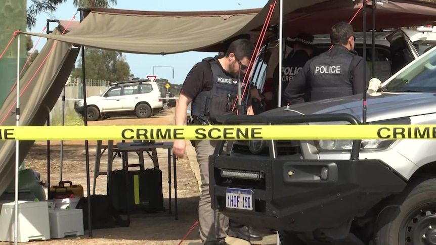 Police at a command post with crime scene tape across the front