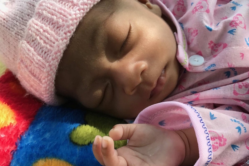 A newborn baby wearing a beanie