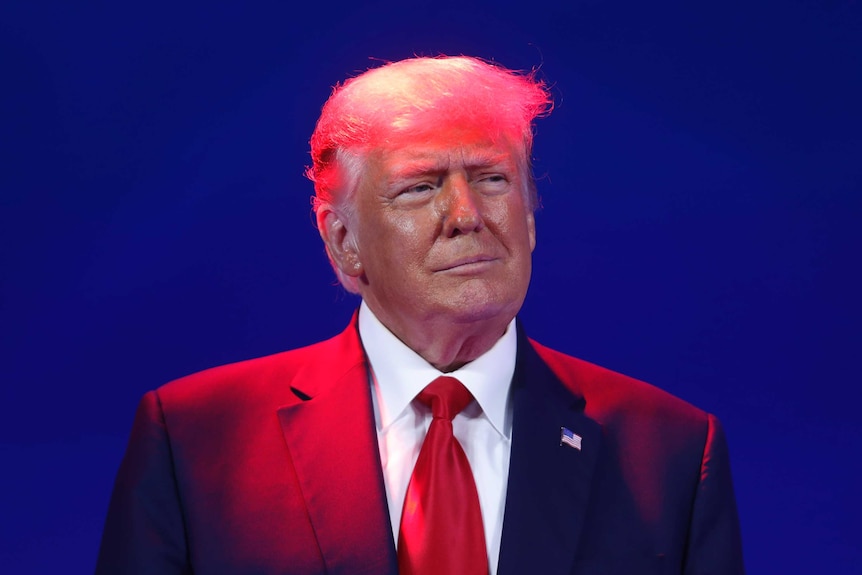 Former U.S. President Donald Trump under a spotlight at the 2021 CPAC conference
