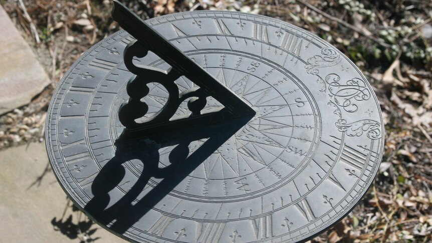 A close-up of a nice bronze sundial in a garden