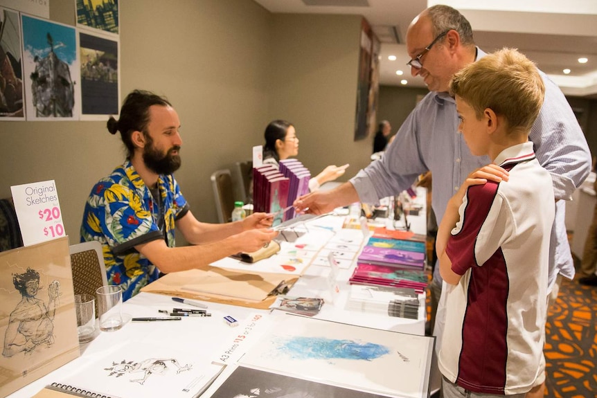 Comic fans browse the market day stalls at the inaugural Australian Comic Arts Festival.