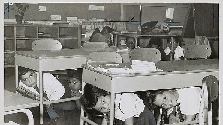 American schoolchildren practice taking shelter under their desks.